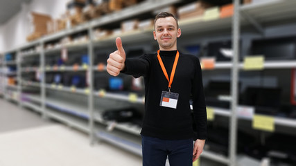 Portrait of best a Professional Expert Consultant. Smiles and Looks into Camera, showing thumbs up. Blurred background