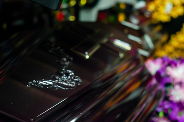 closeup shot of a colorful casket in a hearse or chapel before funeral or burial at cemetery