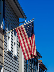 The old Betsy Ross American flag hanging on a house