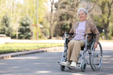 Senior woman in wheelchair at park on sunny day