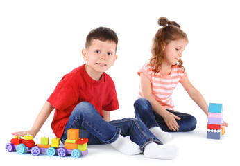 Cute little children playing with toys on white background