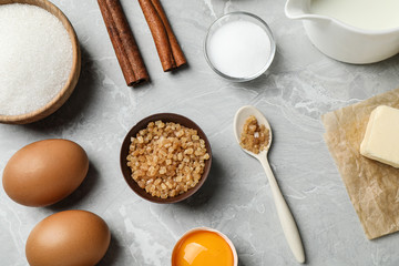 Flat lay composition with fresh ingredients for delicious homemade cake on light grey marble table