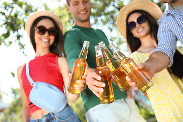 Young people enjoying picnic in park on summer day, closeup