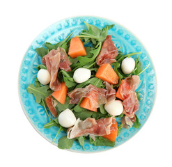 Fresh melon with prosciutto, mozzarella and arugula on white background, top view