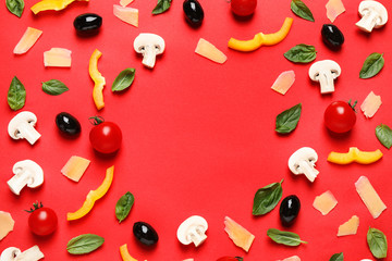 Flat lay composition with fresh pizza ingredients on red background. Space for text