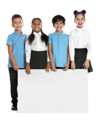 Happy children in school uniform with blank board on white background