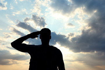 Soldier in uniform saluting outdoors. Military service - obrazy, fototapety, plakaty
