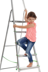 Little girl climbing up ladder on white background. Danger at home