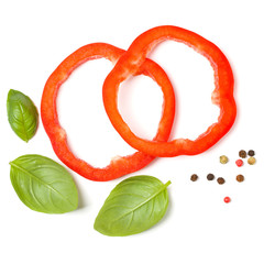 red pepper slices with basil leaves isolated on white background cutout. Top view, flat lay.