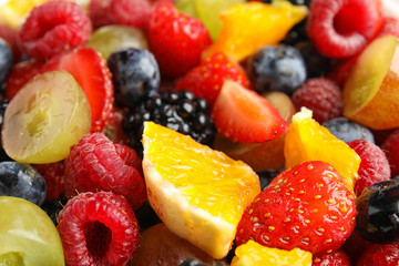 Fresh tasty fruit salad as background, closeup