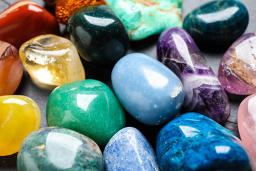 Different precious gemstones as background, closeup view