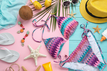 Flat lay composition with beach accessories on colorful background