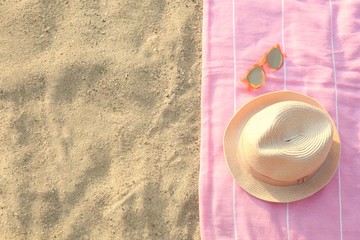 Beach accessories on sand, flat lay. Space for text