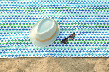Fototapeta na wymiar Bright beach accessories on sand, top view