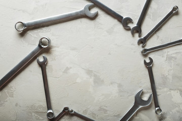 Spanners. Many wrenches. Industrial background. Set of wrench tool equipment. Set of wrenches in different sizes on grey background. Top view with copy space.
