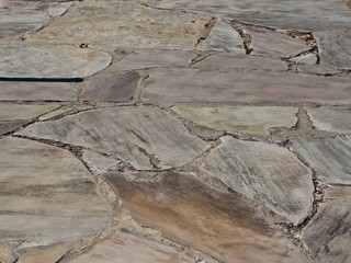 A tan rock wall or floor