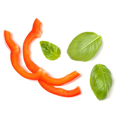 red pepper slices with basil leaves isolated on white background cutout. Top view, flat lay.