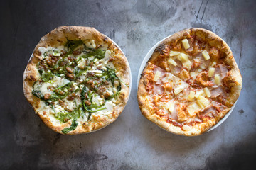 Two Pizzas  on a Concrete Background