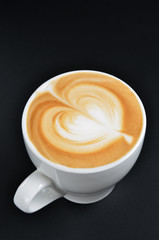 Cup of art latte on a cappuccino coffee