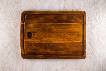 Wooden cutting board on a gray marble background