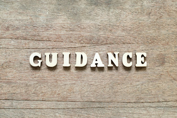 Letter block in word guidance on wood background