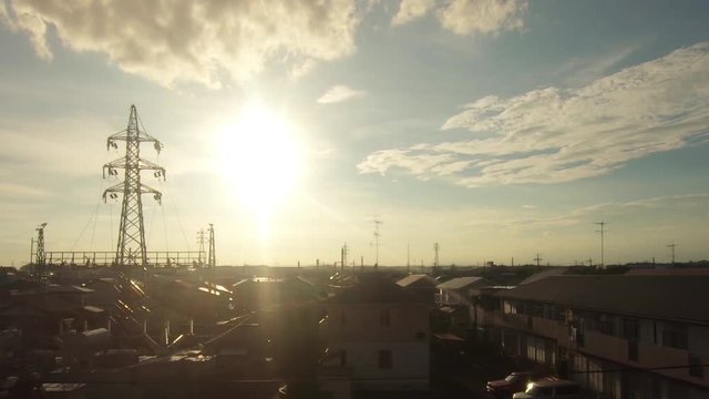 Japan Railway train window. Sunlight and residential area