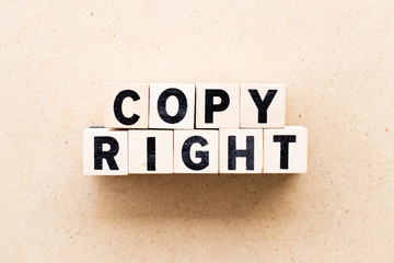 Letter block in word copyright on wood background