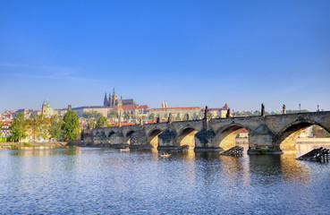 A view across the Charles Bridge and the Vltava River to Prague Castle and St. Vitas Cathedral in Prague, Czech Republic.