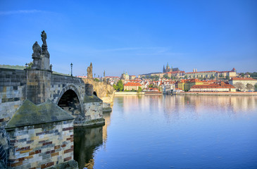 A view across the Charles Bridge and the Vltava River to Prague Castle and St. Vitas Cathedral in Prague, Czech Republic.