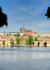 A view across the Charles Bridge and the Vltava River to Prague Castle and St. Vitas Cathedral in Prague, Czech Republic.