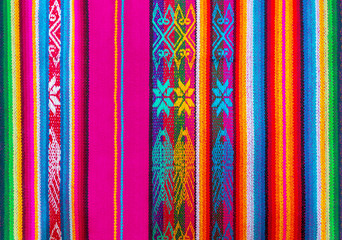 Colorful Andes textiles on the art and craft market of Otavalo, north of Quito, in Ecuador. These...