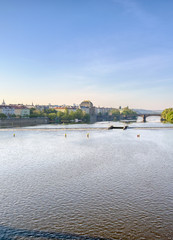 Naklejka premium Early morning view of the along the Vltava River in the city of Prague, Czech Republic.