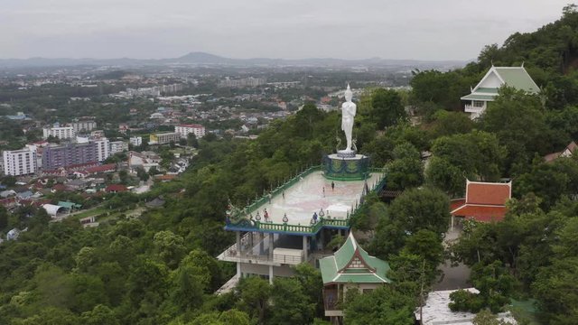 lapse of temple and big Buddha statue footage video 4k. Sriracha Thailand. Aerial view of Buddha statue in Wat khao phra kru temple located in Sriracha city Chonburi, Thailand