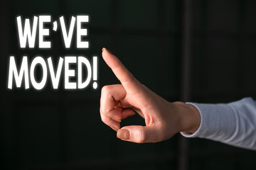 Writing note showing We Ve Moved. Business concept for To go from one residence or location to another Relocate Finger pointing in the Dark with hand pointing in the copy space