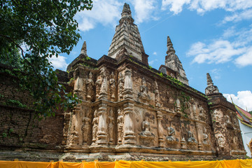 Fototapeta na wymiar Wat Jed Yod an iconic Indian style viharn with 7 chedis on top located outskirts of Chiang Mai province of Thailand.