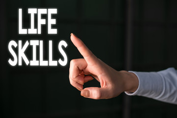 Writing note showing Life Skills. Business concept for skill that is necessary for full participation in everyday life Finger pointing in the Dark with hand pointing in the copy space