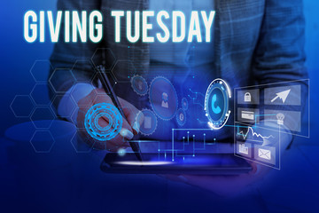 Text sign showing Giving Tuesday. Business photo showcasing international day of charitable giving Hashtag activism Woman wear formal work suit presenting presentation using smart device