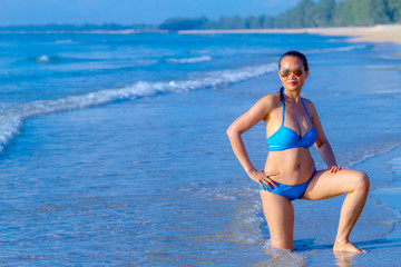 Woman show sexy happy with bikini blue at the beach