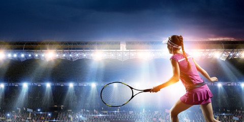 Young woman playing tennis in action