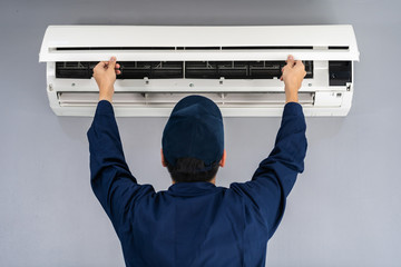 technician service checking and repairing air conditioner