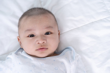 happy baby lying on a bed