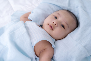 happy baby lying on a bed