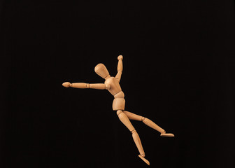 jump happy wooden mannequin black background