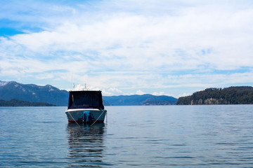 Fototapeta na wymiar Boats sailing on calm lake water.