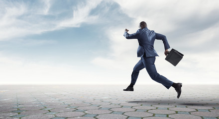 Running black businessman with briefcase isolated