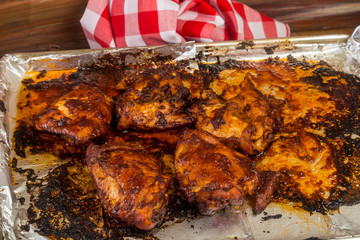 Chicken Thighs basted in Spicy Adobo Sauce on Cookie Sheet covered in Aluminum Foil