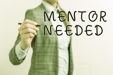 Writing note showing Mentor Needed. Business concept for wanted help for more experienced or more knowledgeable demonstrating Business woman pointing in empty space with pen