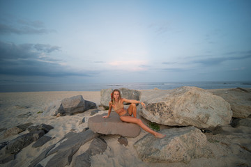 Beautiful young woman in bikini on the beach