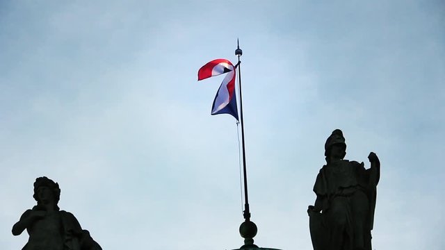 Flag of France Waving Proudly Among Sculptures Over an Old Building in Paris.
