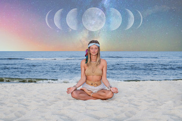 Beautiful woman is practicing yoga on the beach on Milky Way background.